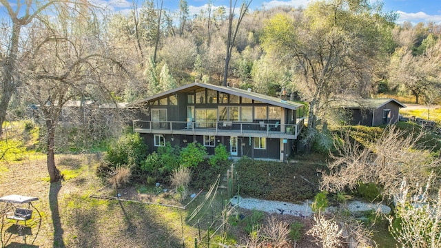 view of front of house featuring a view of trees