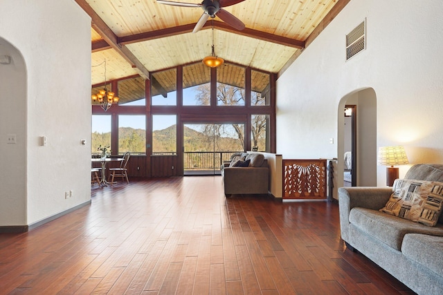 living room featuring visible vents, arched walkways, dark wood finished floors, wooden ceiling, and beam ceiling