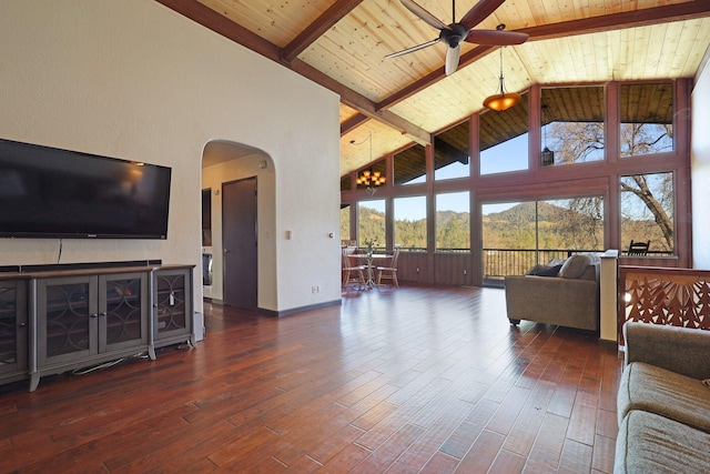 living room with arched walkways, wood finished floors, high vaulted ceiling, wooden ceiling, and beamed ceiling