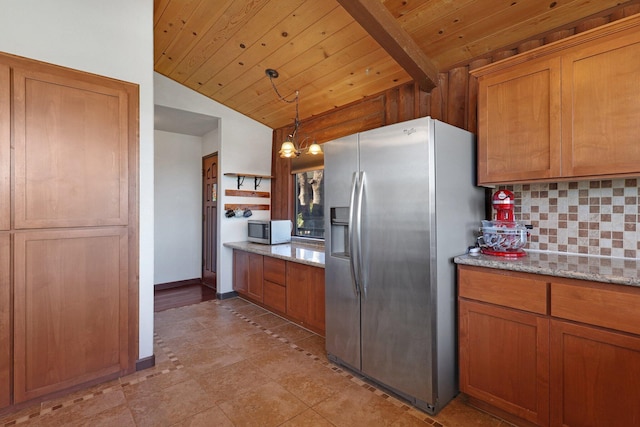 kitchen with appliances with stainless steel finishes, brown cabinetry, and decorative backsplash