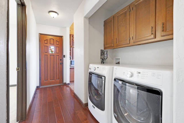 clothes washing area with dark wood-type flooring, cabinet space, independent washer and dryer, and baseboards