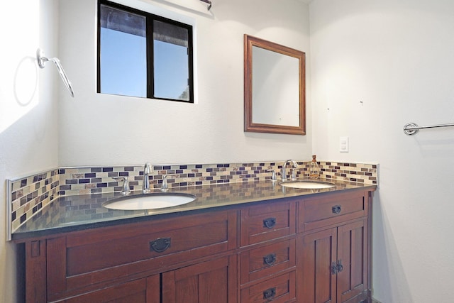 bathroom featuring a sink, backsplash, and double vanity