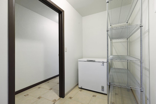 clothes washing area with baseboards