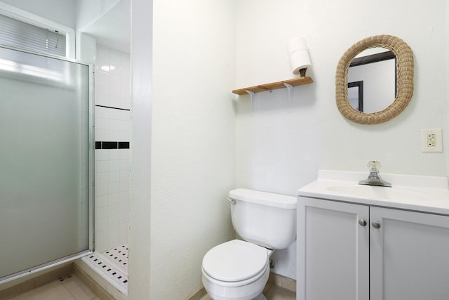 full bath featuring a stall shower, vanity, toilet, and baseboards