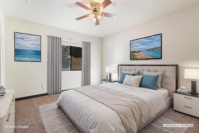 bedroom featuring a ceiling fan, light carpet, and baseboards