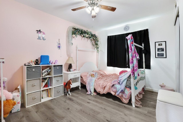 bedroom with a ceiling fan and wood finished floors