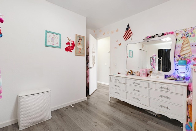 bedroom with light wood-type flooring and baseboards