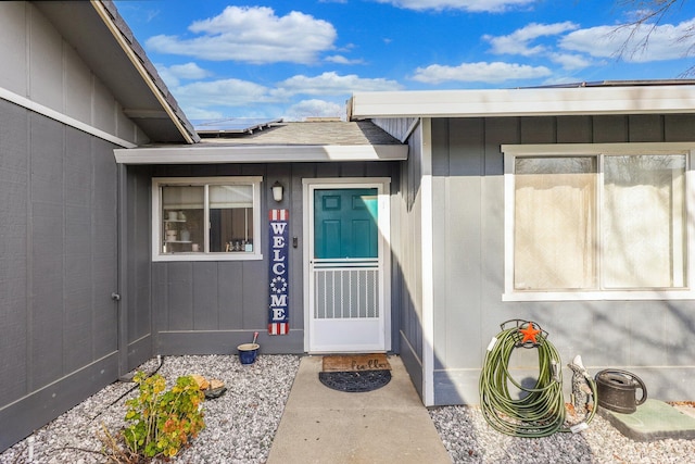 doorway to property featuring roof mounted solar panels