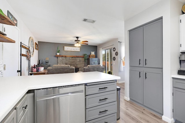 kitchen featuring gray cabinets, light countertops, visible vents, dishwasher, and a peninsula