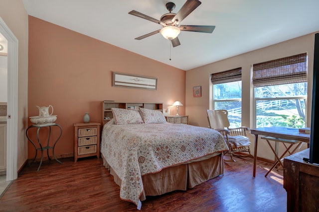 bedroom with ceiling fan, baseboards, vaulted ceiling, and dark wood-style flooring