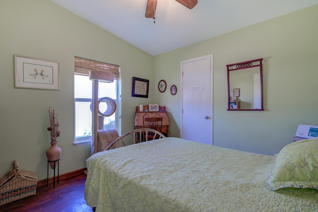 bedroom with a ceiling fan, baseboards, vaulted ceiling, and dark wood-style flooring