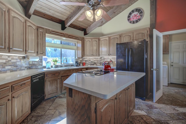 kitchen featuring black appliances, a kitchen island, light countertops, and stone tile floors