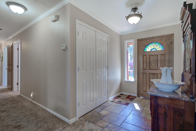 entryway featuring baseboards, stone tile flooring, and ornamental molding