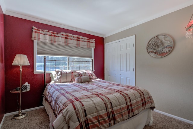 carpeted bedroom featuring a textured wall, baseboards, a closet, and ornamental molding