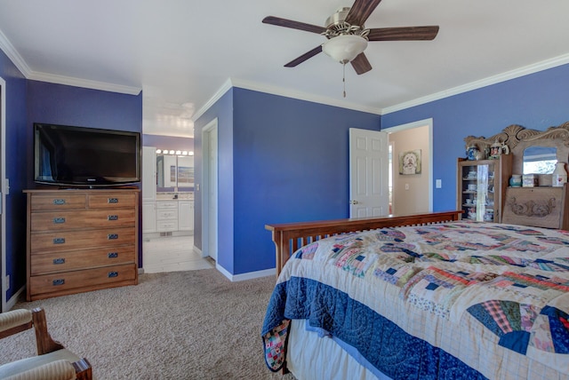 bedroom featuring light carpet, a ceiling fan, baseboards, ornamental molding, and ensuite bath