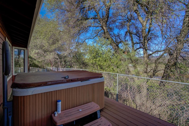 wooden terrace with a hot tub