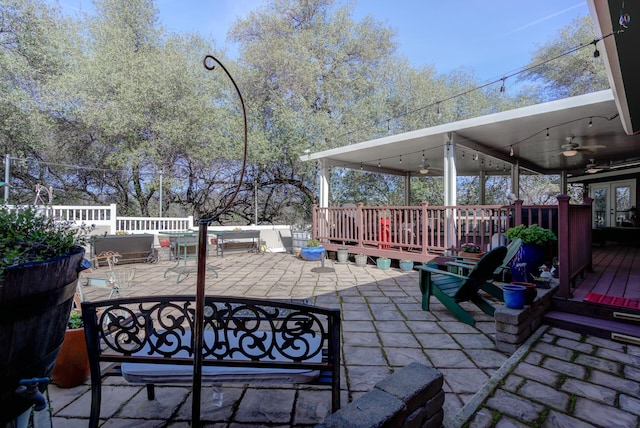 view of patio with outdoor dining space, a ceiling fan, and a wooden deck