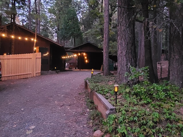 exterior space featuring driveway and fence