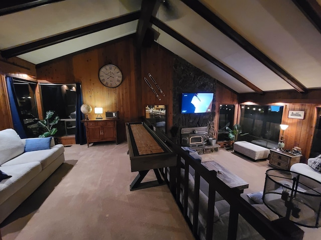 living area with light colored carpet, vaulted ceiling with beams, and wooden walls