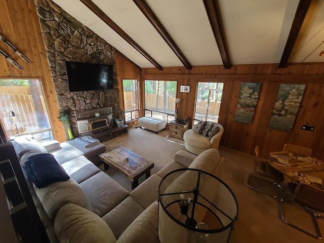 carpeted living room with wooden walls and lofted ceiling with beams