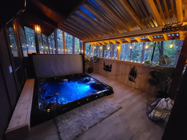 unfurnished sunroom with lofted ceiling and a hot tub