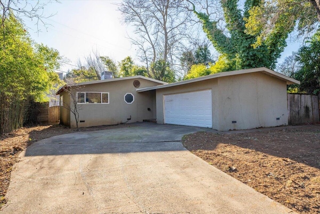 ranch-style home with a garage, crawl space, driveway, and stucco siding