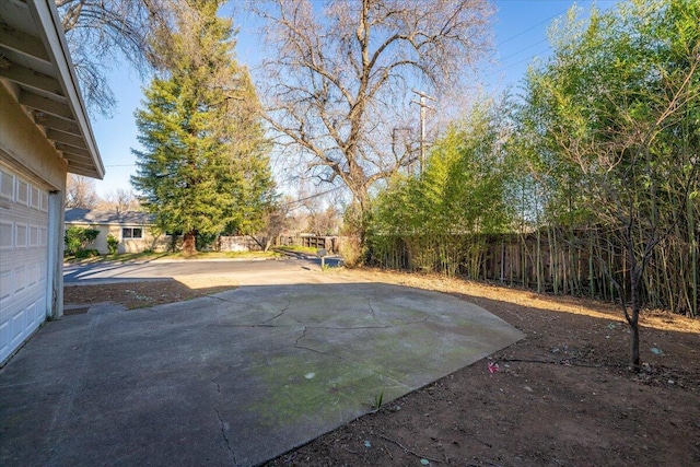 view of yard with a garage and fence private yard