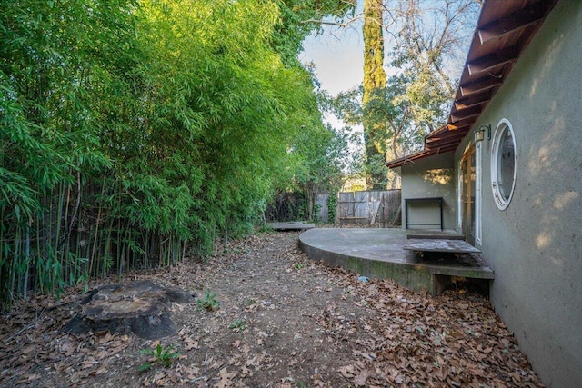 view of yard featuring fence and a patio