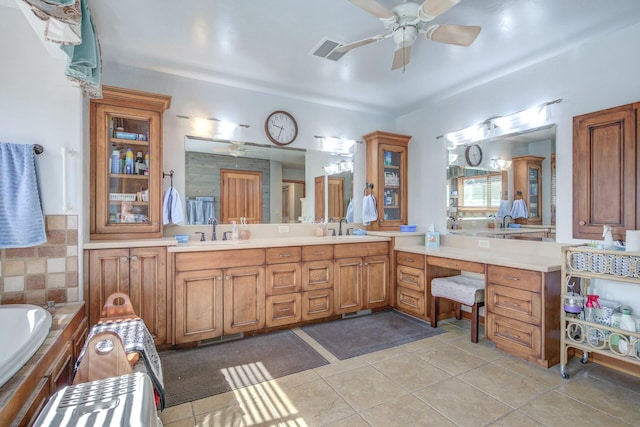 full bathroom featuring double vanity, visible vents, a sink, and tile patterned floors