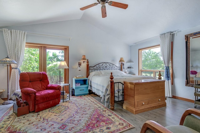 bedroom featuring vaulted ceiling, light wood finished floors, a ceiling fan, and baseboards