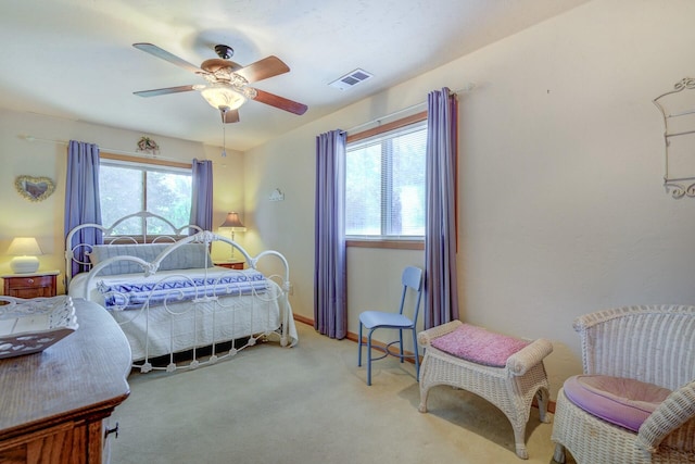 bedroom featuring light carpet, baseboards, visible vents, and a ceiling fan