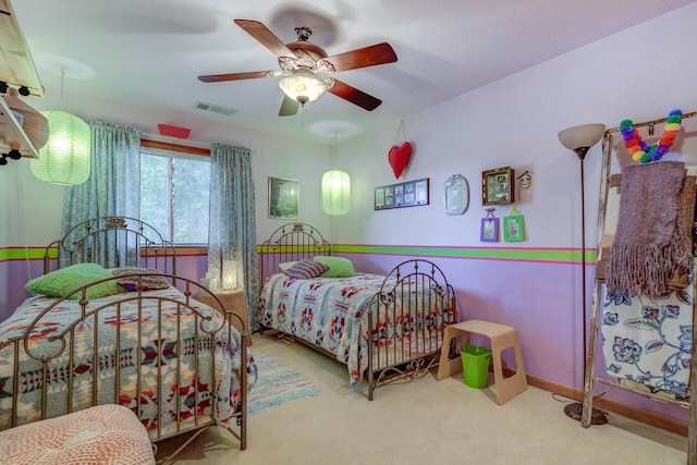 bedroom with a ceiling fan, visible vents, light carpet, and baseboards