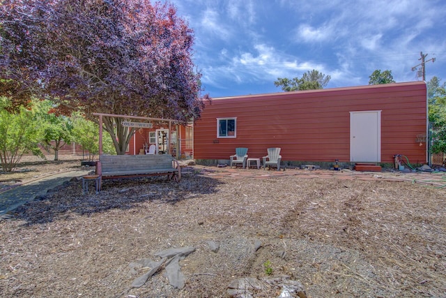 rear view of property featuring entry steps