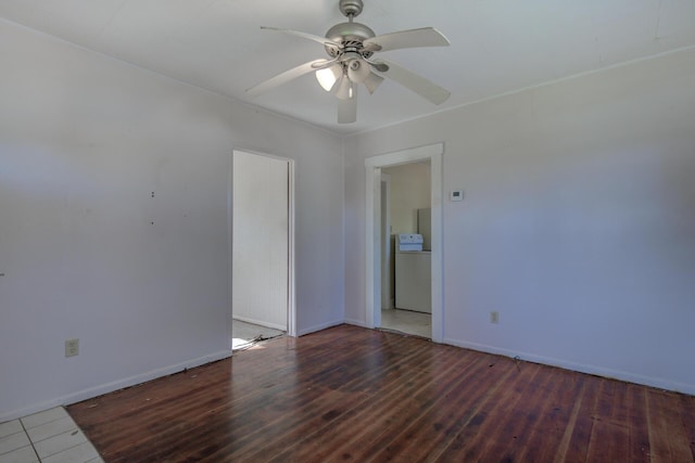 unfurnished room featuring ceiling fan, washer / clothes dryer, dark wood-type flooring, and baseboards