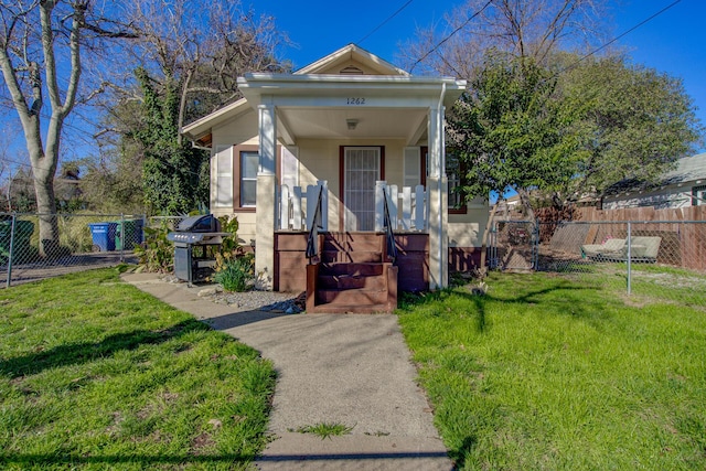 view of front of house with a front yard and fence