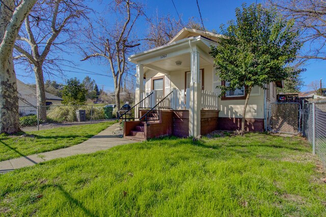 exterior space with a fenced front yard and a front lawn