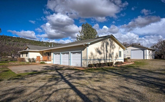 view of property exterior featuring covered porch and driveway