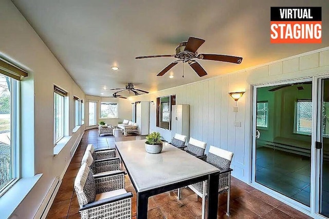 sunroom / solarium featuring plenty of natural light and baseboard heating