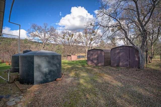 view of yard featuring a shed and an outbuilding