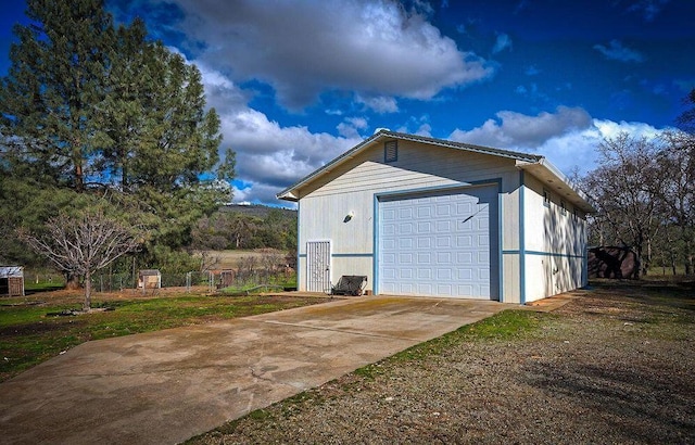 detached garage with concrete driveway