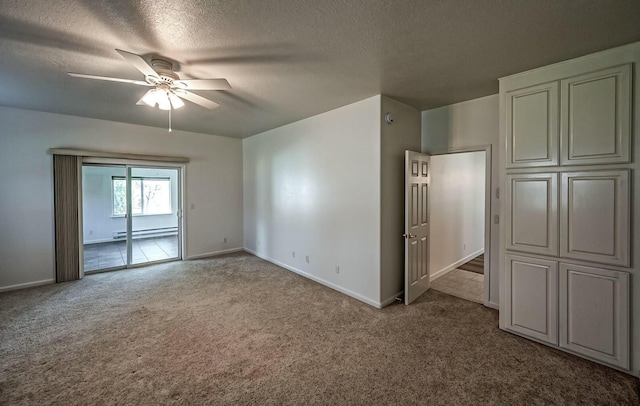 interior space featuring light carpet, a textured ceiling, a baseboard heating unit, and a ceiling fan