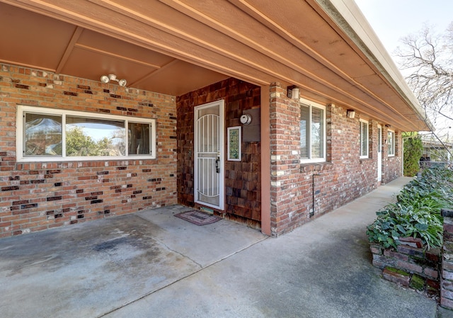 property entrance featuring brick siding