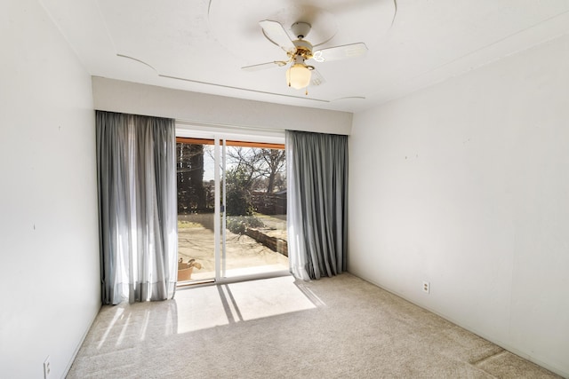 spare room with light carpet and ceiling fan