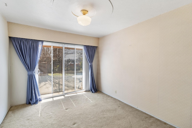 unfurnished room featuring light carpet