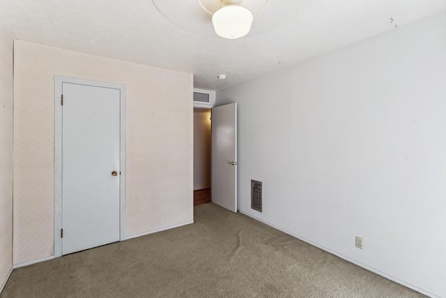 unfurnished bedroom with carpet floors and visible vents