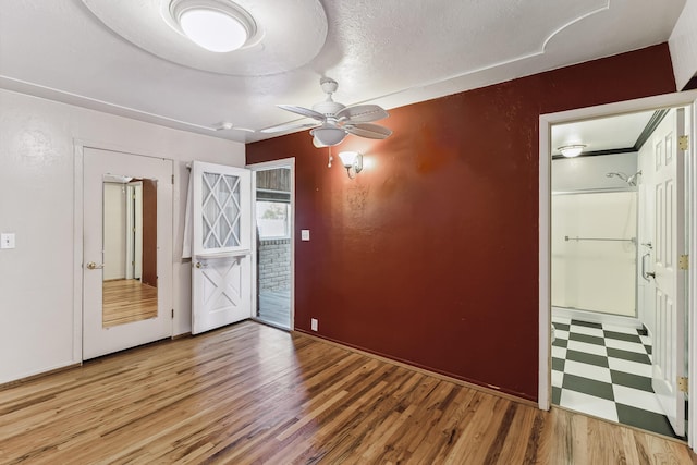 spare room with ceiling fan and a textured ceiling