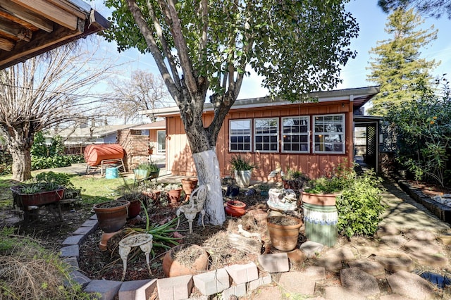 exterior space with brick siding and board and batten siding