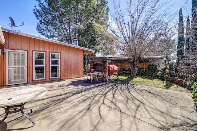 view of patio featuring fence