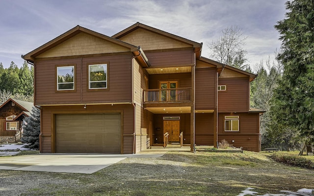 rustic home with concrete driveway, an attached garage, and a balcony