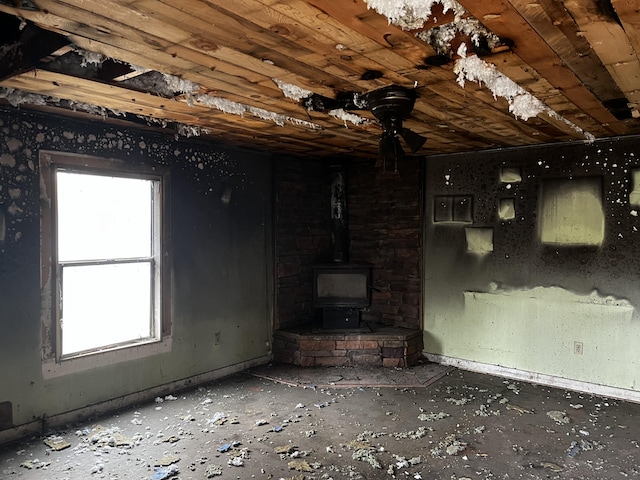 unfurnished living room featuring a wood stove